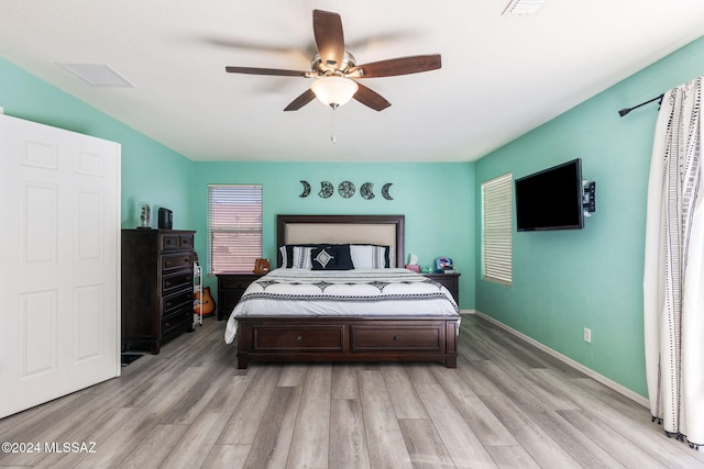 bedroom with light wood-type flooring and ceiling fan