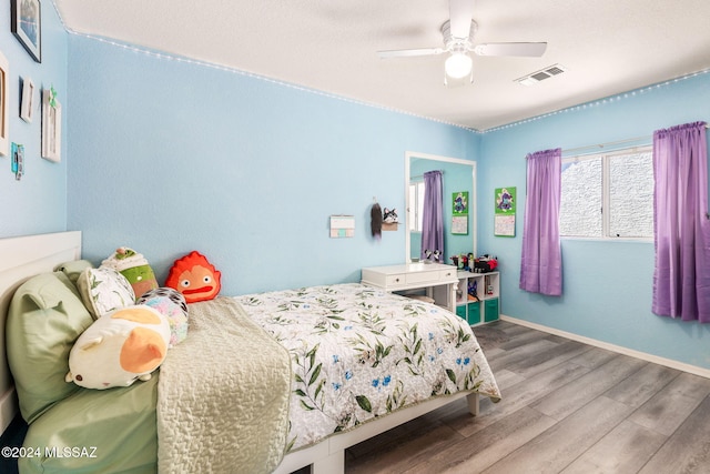 bedroom featuring ceiling fan and hardwood / wood-style flooring