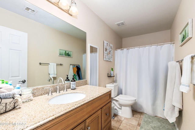 bathroom featuring tile patterned floors, vanity, and toilet