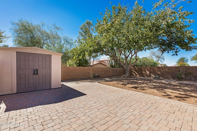 view of patio featuring a storage shed