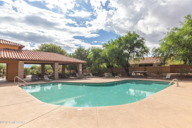 view of swimming pool with a patio