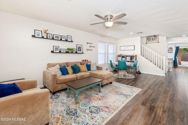 living room featuring dark hardwood / wood-style floors and ceiling fan