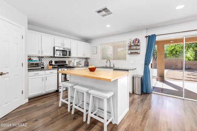 kitchen featuring white cabinets, sink, appliances with stainless steel finishes, and wooden counters