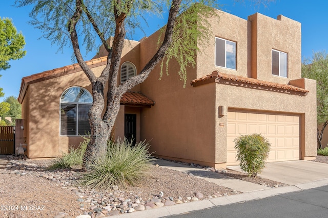 pueblo-style home with a garage