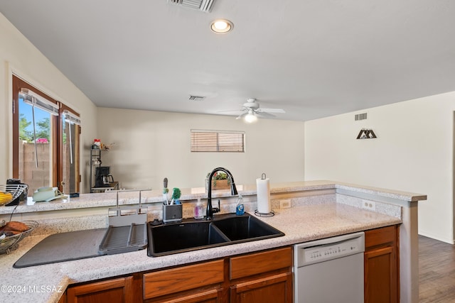 kitchen featuring white dishwasher, ceiling fan, wood-type flooring, and sink