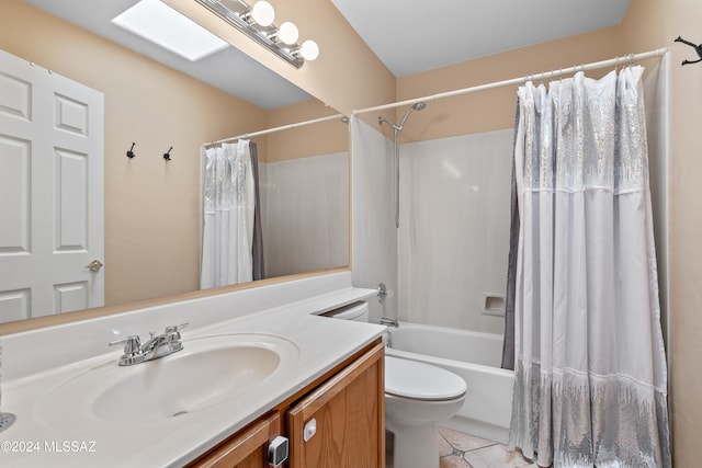 full bathroom with vanity, tile patterned floors, a skylight, toilet, and shower / bath combo with shower curtain