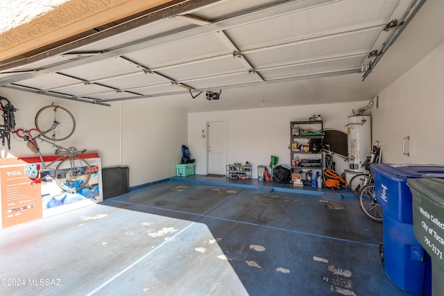 garage with a garage door opener and water heater