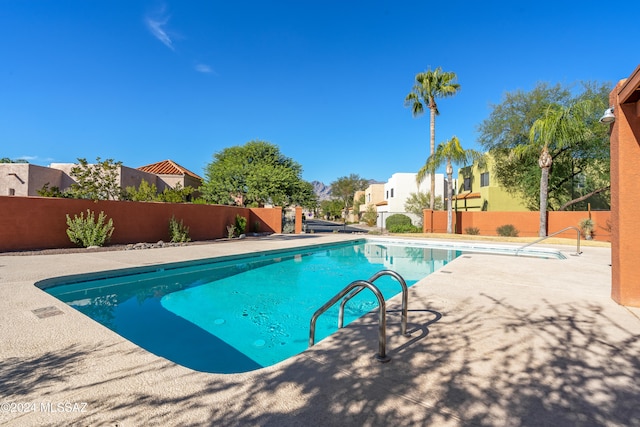 view of swimming pool with a patio area