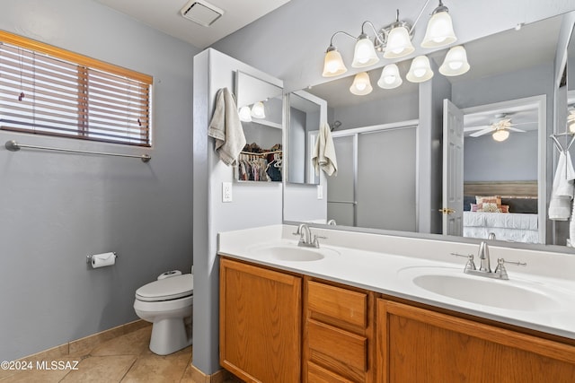 bathroom with a shower with door, tile patterned floors, toilet, ceiling fan, and vanity