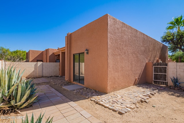 rear view of property featuring a patio area