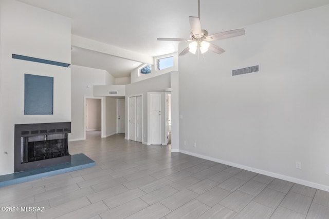 unfurnished living room featuring beamed ceiling, light hardwood / wood-style flooring, high vaulted ceiling, and ceiling fan