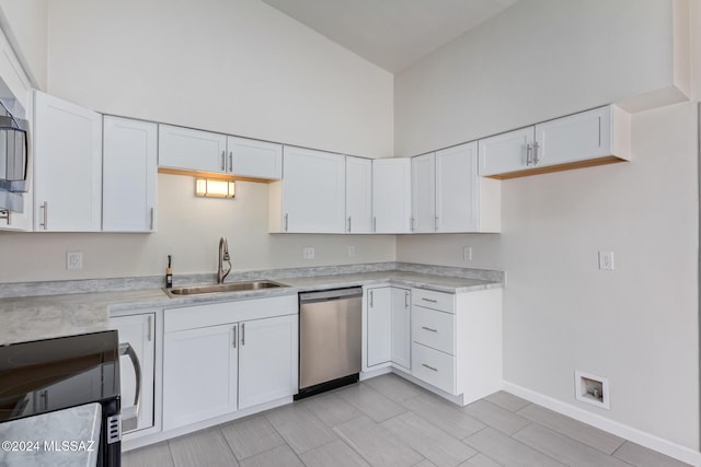 kitchen with sink, high vaulted ceiling, dishwasher, and white cabinets