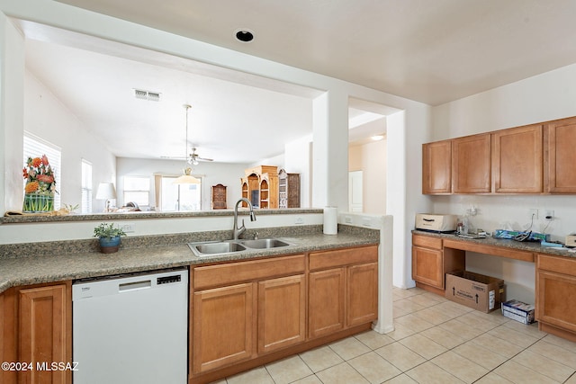 kitchen featuring sink, light tile patterned flooring, built in desk, and white dishwasher