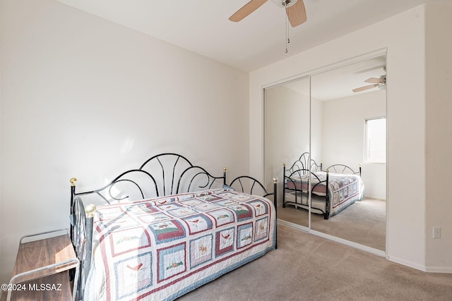 carpeted bedroom featuring a closet and ceiling fan