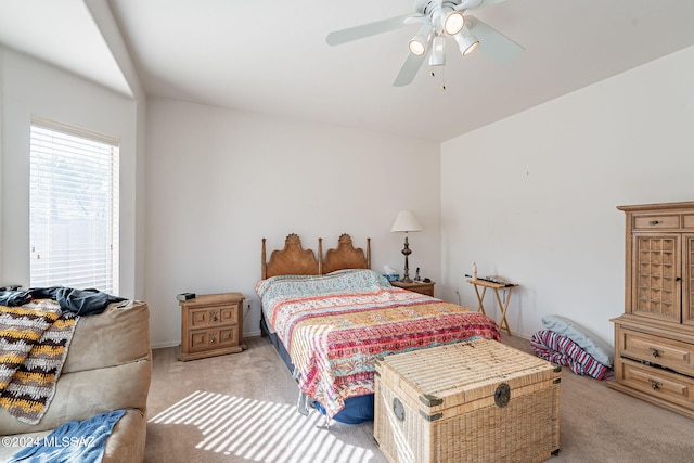 bedroom featuring light colored carpet and ceiling fan