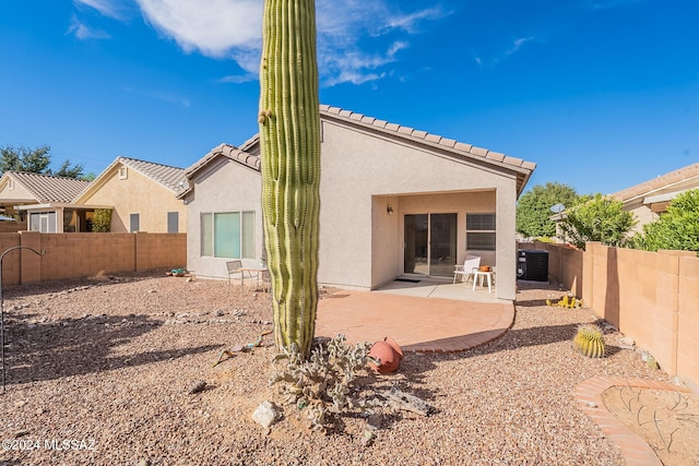 rear view of property featuring a patio area and central AC unit