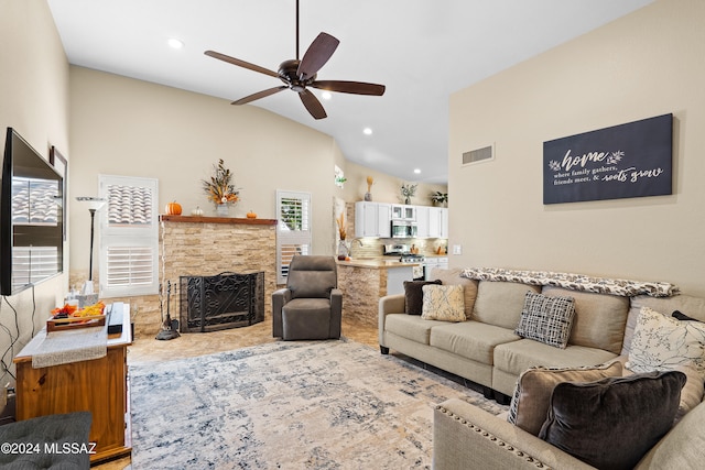 living room with vaulted ceiling, a fireplace, and ceiling fan