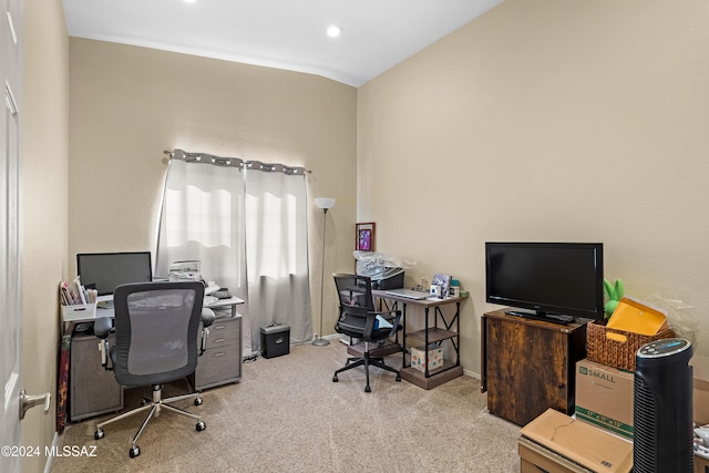 home office featuring vaulted ceiling and light carpet