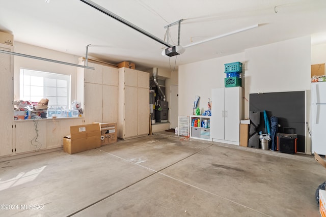 garage featuring a garage door opener and white refrigerator