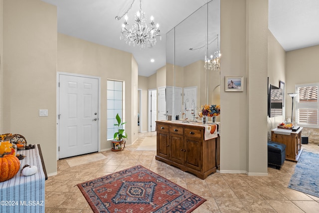 tiled entrance foyer with a notable chandelier