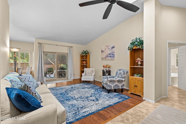 living room featuring vaulted ceiling, light wood-type flooring, and ceiling fan