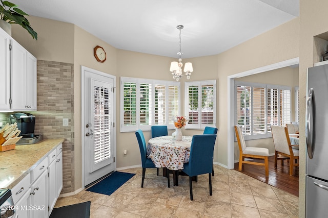 dining area featuring an inviting chandelier and light wood-type flooring