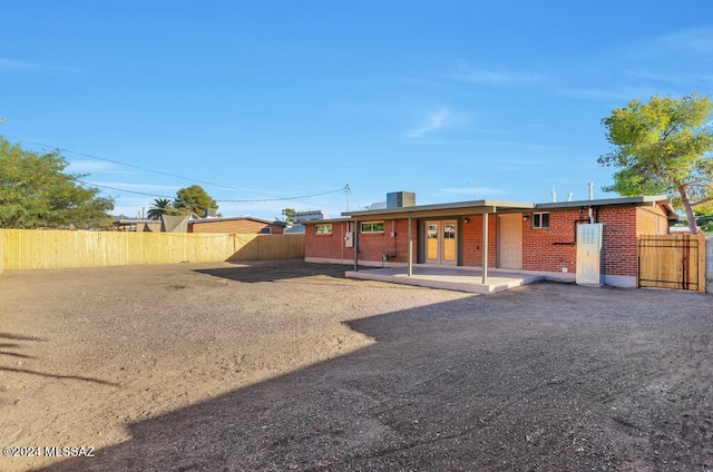 back of house with a patio, brick siding, and fence