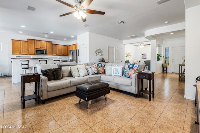 living room with ceiling fan and light tile patterned floors