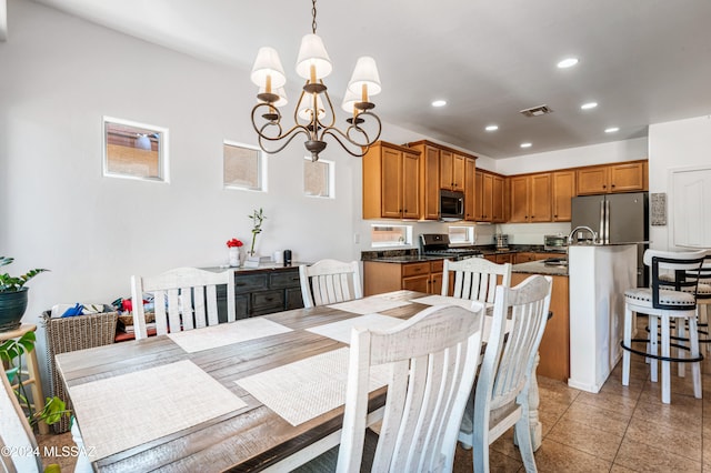 dining area featuring light tile patterned flooring and a chandelier