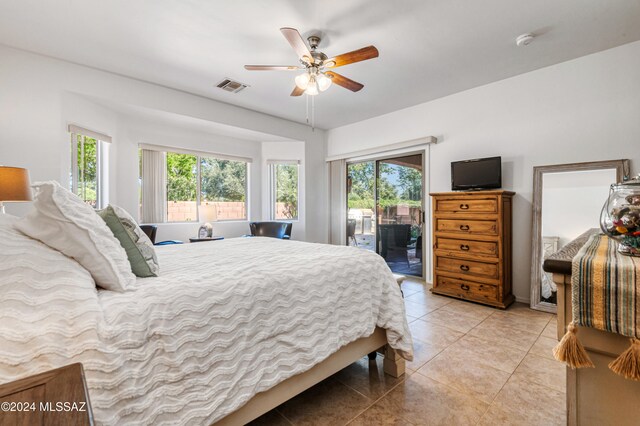 tiled bedroom featuring access to outside and ceiling fan