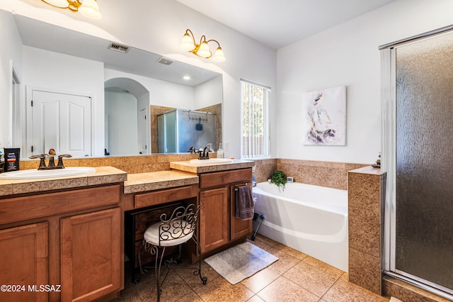 bathroom with tile patterned floors, vanity, and independent shower and bath