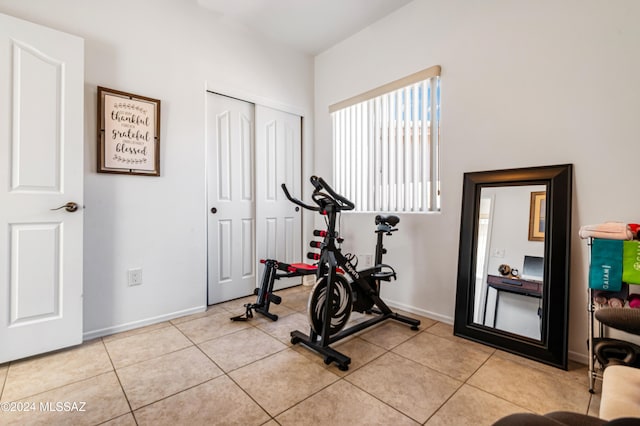 exercise room with light tile patterned floors