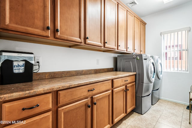 washroom featuring cabinets and independent washer and dryer