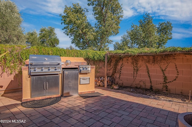 view of patio / terrace featuring a grill and exterior kitchen