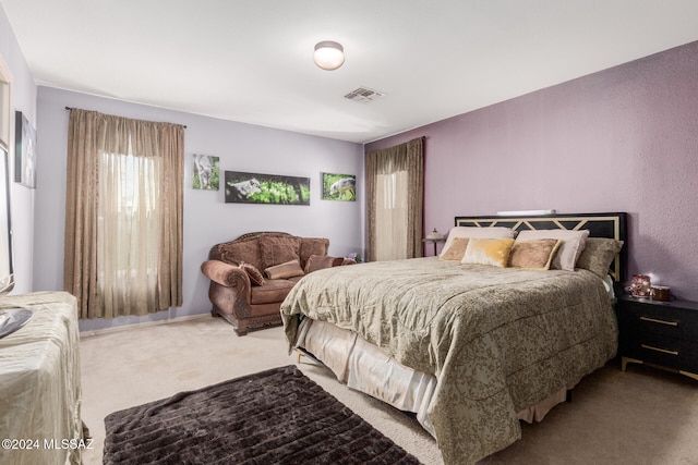 bedroom featuring light carpet