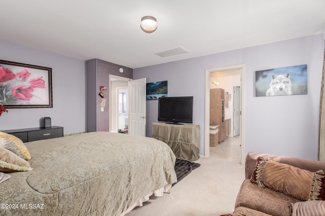 carpeted bedroom featuring ensuite bathroom