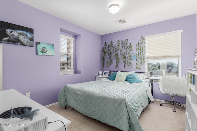 bedroom featuring light carpet