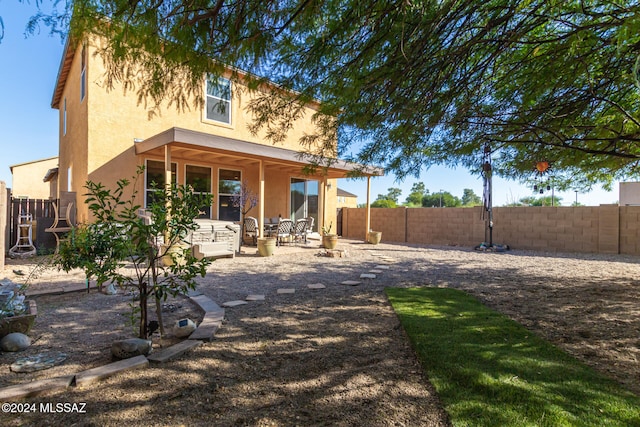 back of house with a patio area