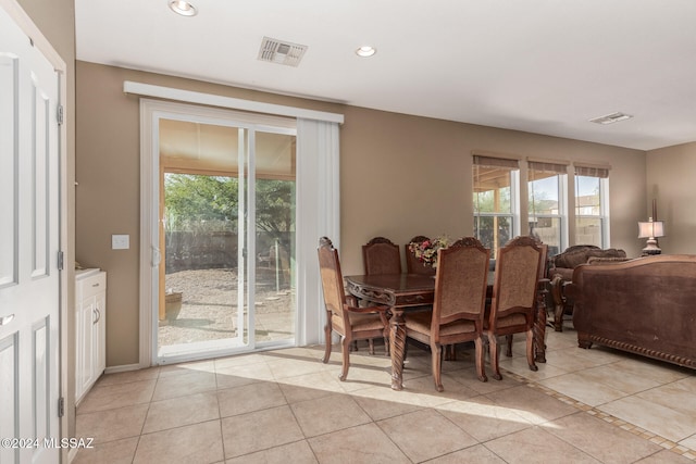 tiled dining space featuring plenty of natural light