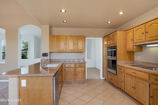 kitchen featuring light stone countertops, appliances with stainless steel finishes, sink, kitchen peninsula, and light tile patterned floors