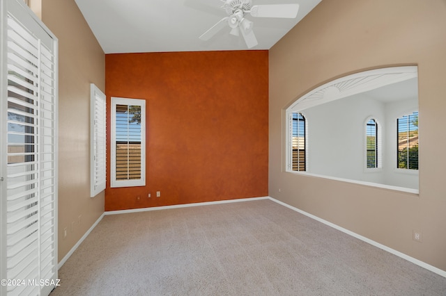 empty room with ceiling fan and carpet flooring