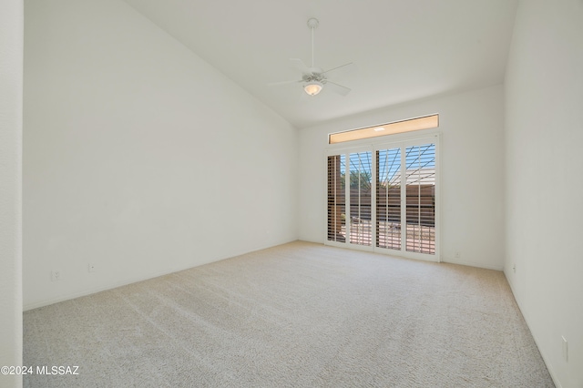 carpeted spare room with vaulted ceiling and ceiling fan