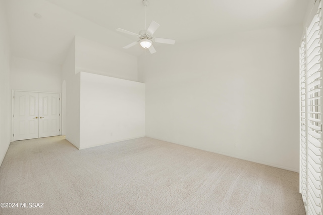 bonus room with light colored carpet and ceiling fan