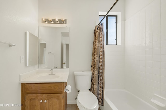 full bathroom featuring vanity, shower / tub combo, and toilet