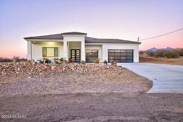 view of front facade featuring a garage and a porch