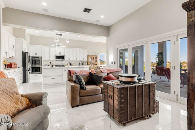 living room with french doors and a high ceiling