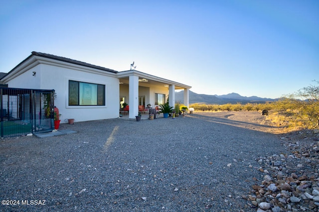 view of front of property featuring a mountain view and a patio area