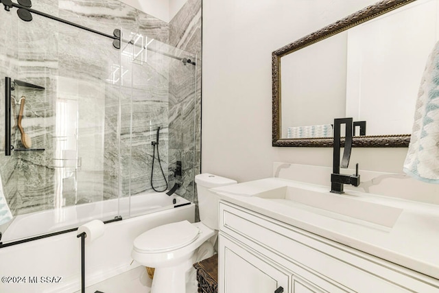 full bathroom featuring vanity, toilet, and combined bath / shower with glass door