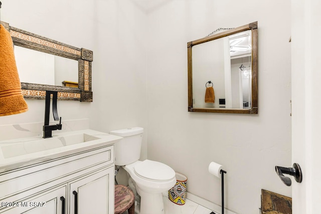 bathroom with vanity, toilet, and tile patterned floors