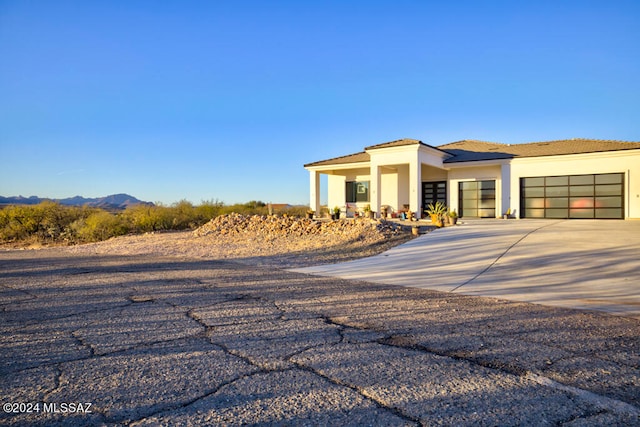 view of front of house featuring a mountain view and a garage